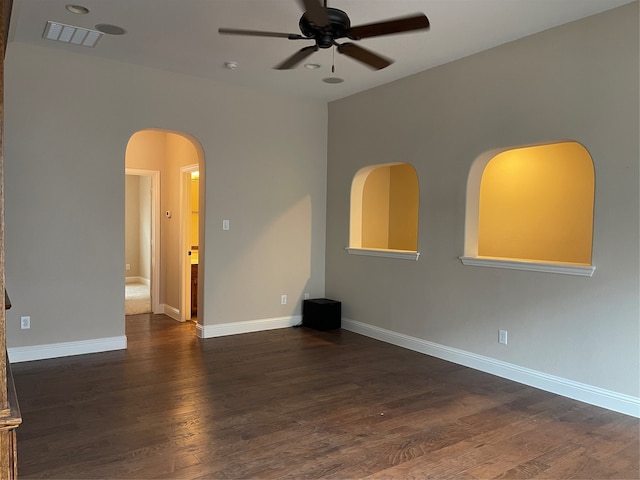 spare room with dark wood-type flooring and ceiling fan