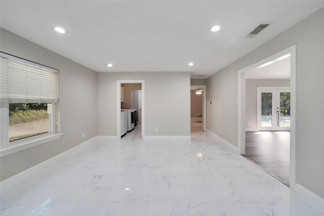 empty room with french doors and a healthy amount of sunlight