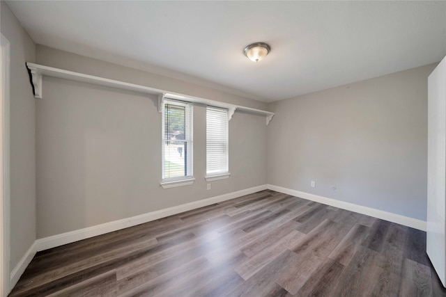 unfurnished room with wood-type flooring