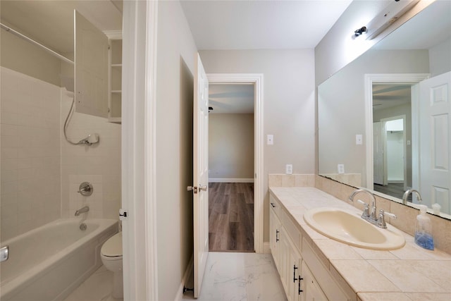 full bathroom with toilet, tiled shower / bath combo, vanity, and wood-type flooring