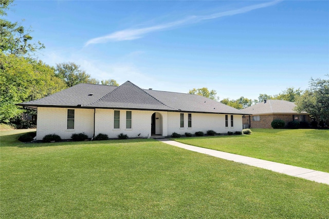 single story home featuring a front lawn