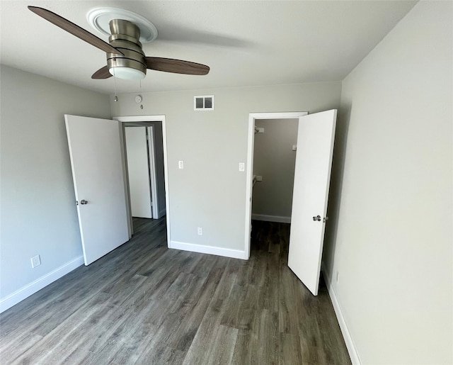 unfurnished bedroom featuring dark hardwood / wood-style floors and ceiling fan