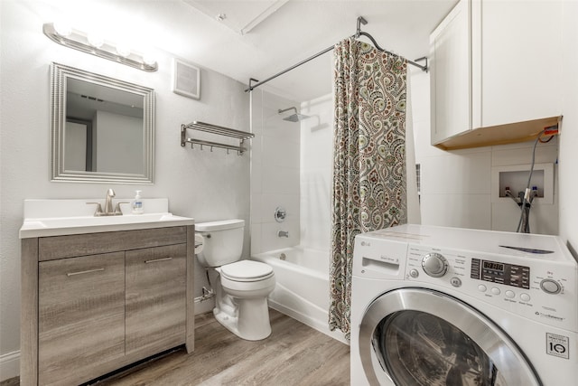 full bathroom featuring washer / dryer, wood-type flooring, toilet, shower / bath combo, and vanity