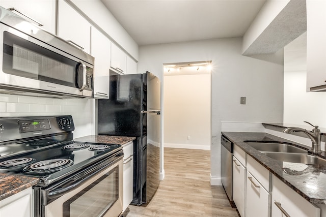 kitchen featuring light hardwood / wood-style flooring, backsplash, sink, black appliances, and white cabinets