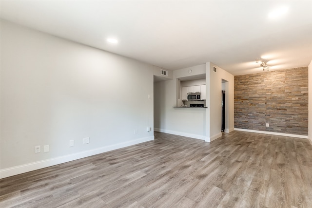 unfurnished living room featuring light wood-type flooring