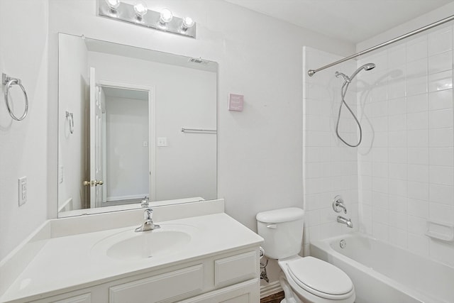 full bathroom with toilet, tiled shower / bath combo, and vanity