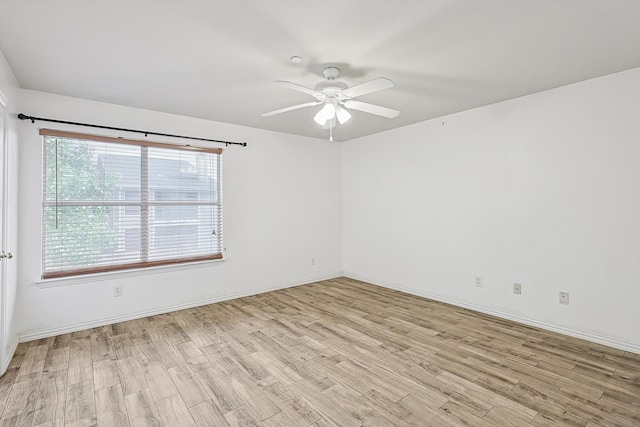 empty room with light wood-type flooring and ceiling fan