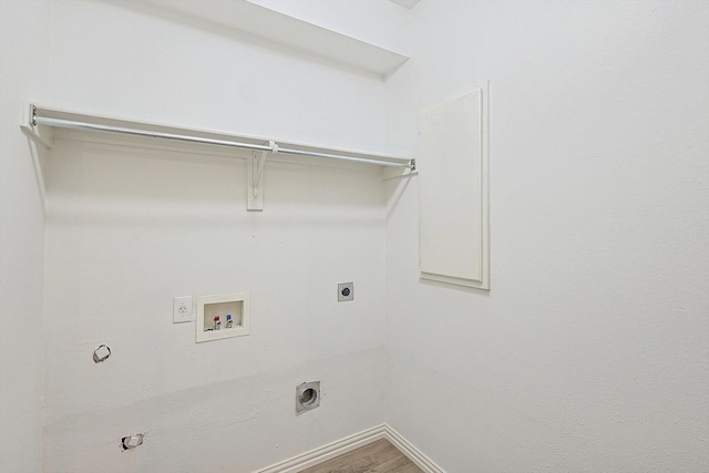 laundry area with gas dryer hookup, hookup for an electric dryer, hardwood / wood-style flooring, and washer hookup