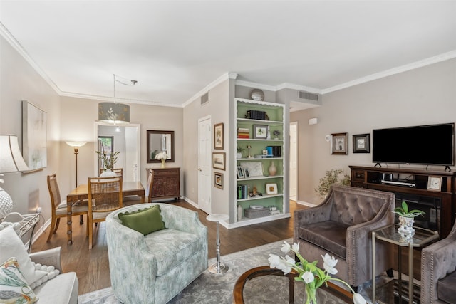 living room with crown molding and dark hardwood / wood-style floors