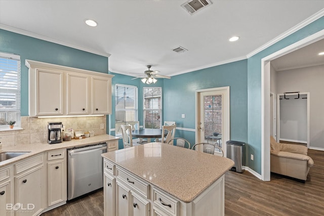 kitchen with dishwasher, a center island, tasteful backsplash, ornamental molding, and dark hardwood / wood-style flooring