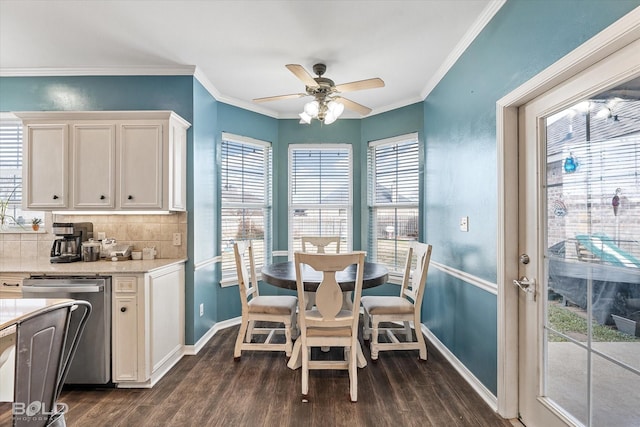 dining space featuring dark hardwood / wood-style flooring, ornamental molding, and ceiling fan