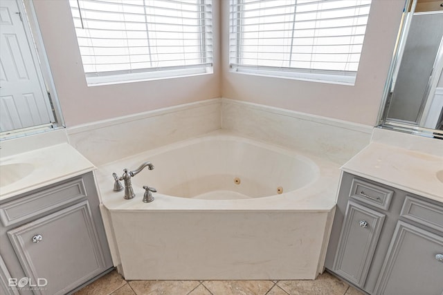 bathroom featuring tile patterned floors, vanity, and shower with separate bathtub