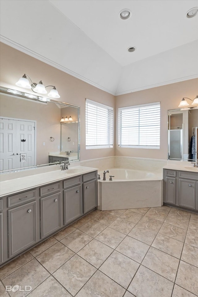 bathroom with tile patterned floors, shower with separate bathtub, vaulted ceiling, ornamental molding, and vanity