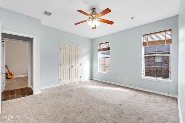 unfurnished bedroom featuring a closet, ceiling fan, and carpet flooring