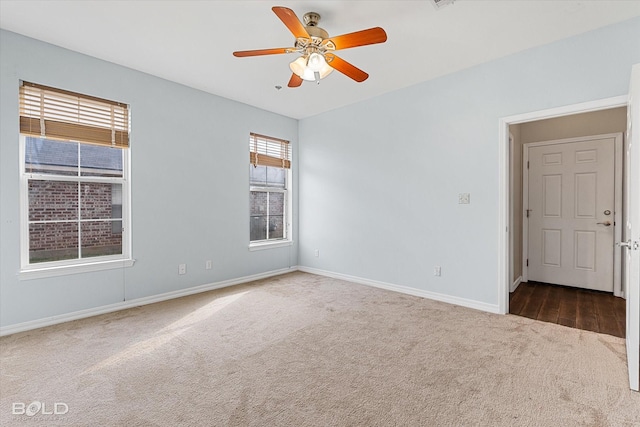 carpeted spare room with ceiling fan