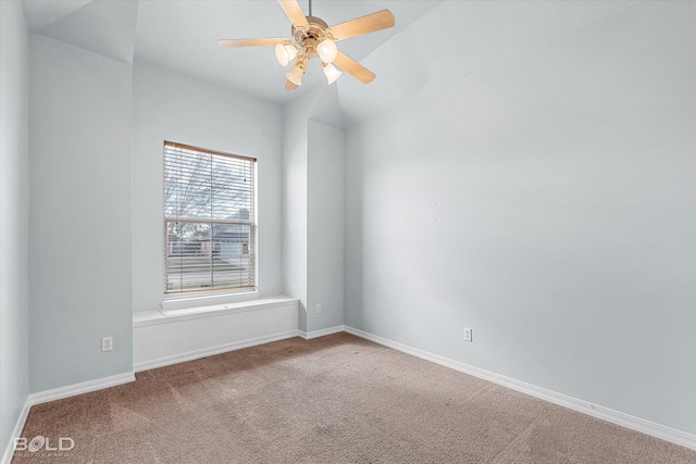 carpeted spare room featuring ceiling fan