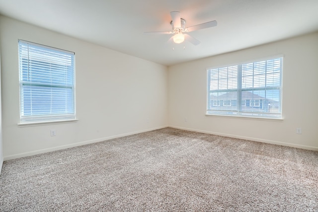 empty room with carpet flooring and ceiling fan