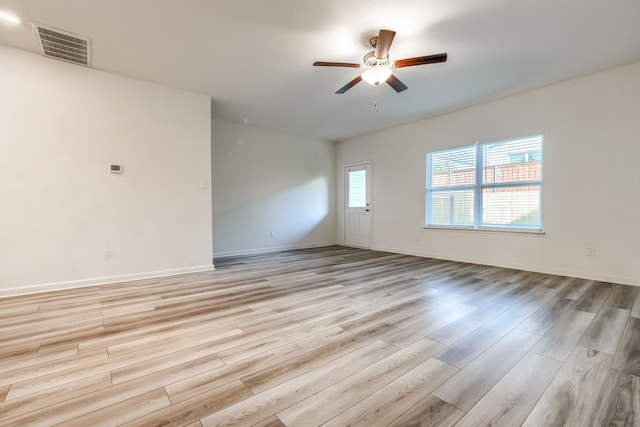 spare room with light hardwood / wood-style floors and ceiling fan