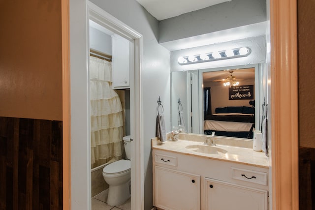 bathroom featuring ceiling fan, toilet, vanity, a shower with curtain, and tile patterned floors