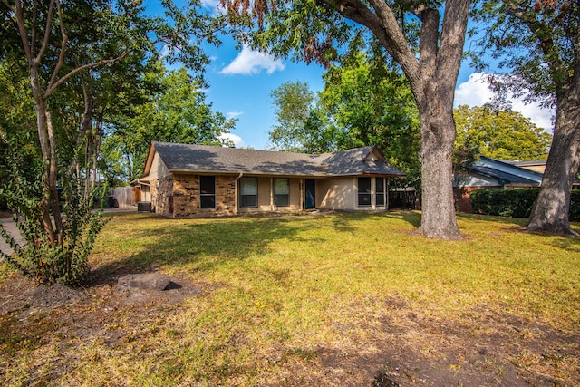 ranch-style house featuring central AC and a front lawn