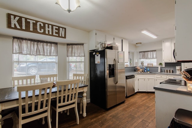 kitchen with white cabinetry, dark wood-type flooring, stainless steel appliances, and sink