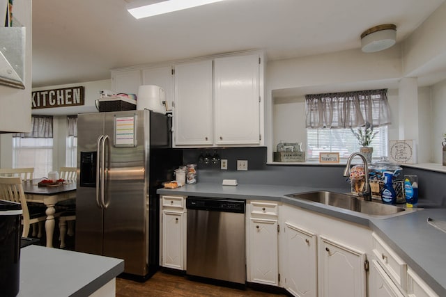 kitchen featuring sink, white cabinetry, stainless steel appliances, and dark wood-type flooring