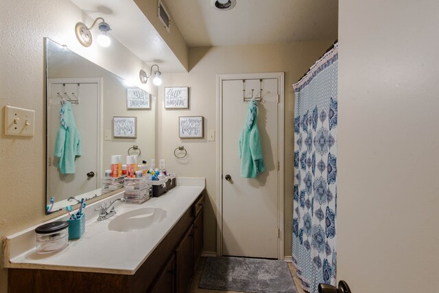 bathroom featuring a shower with curtain and vanity