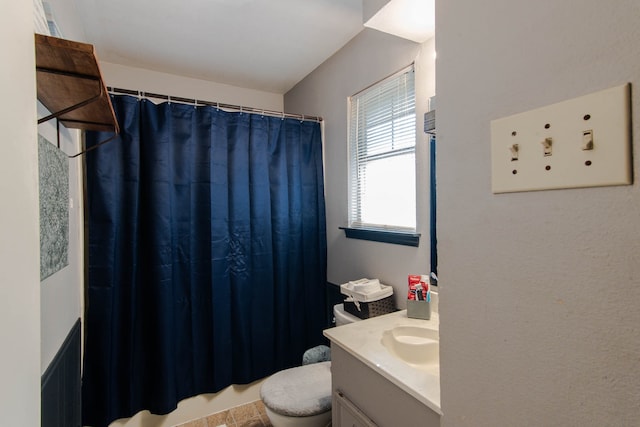 bathroom featuring vanity, a shower with shower curtain, and toilet