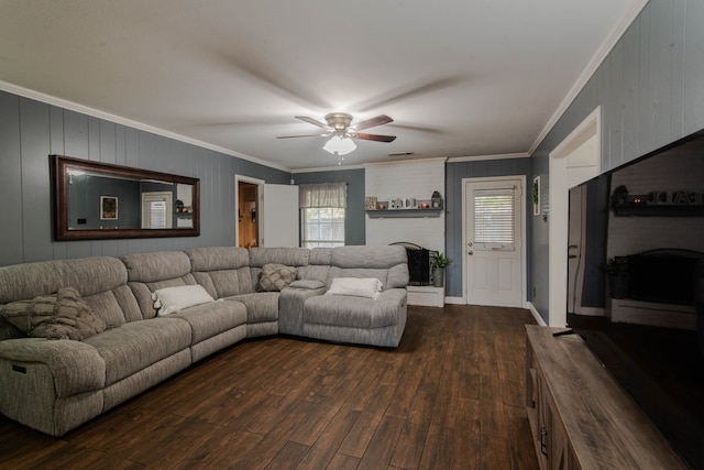 living room featuring crown molding, a fireplace, ceiling fan, and dark hardwood / wood-style floors