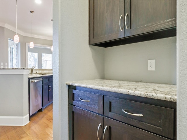 kitchen with dark brown cabinets, light stone countertops, dishwasher, ornamental molding, and light hardwood / wood-style floors