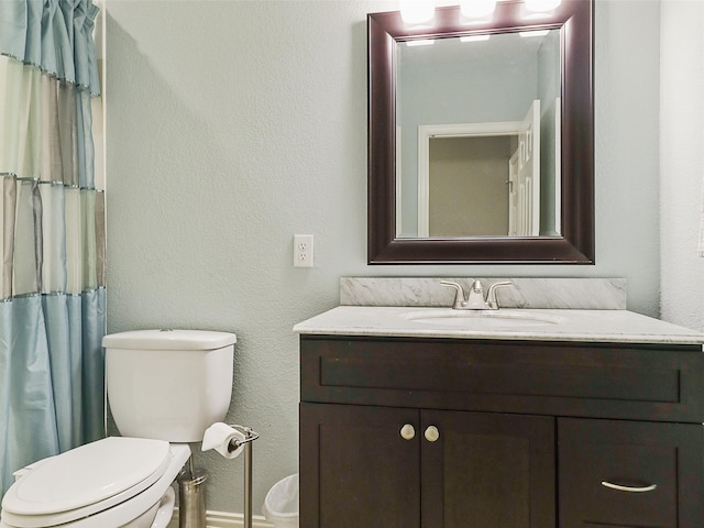 bathroom with toilet and vanity