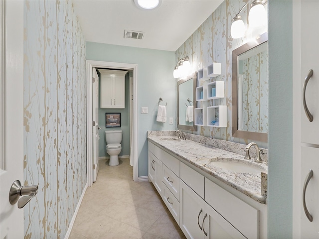 bathroom featuring toilet, vanity, and tile patterned flooring