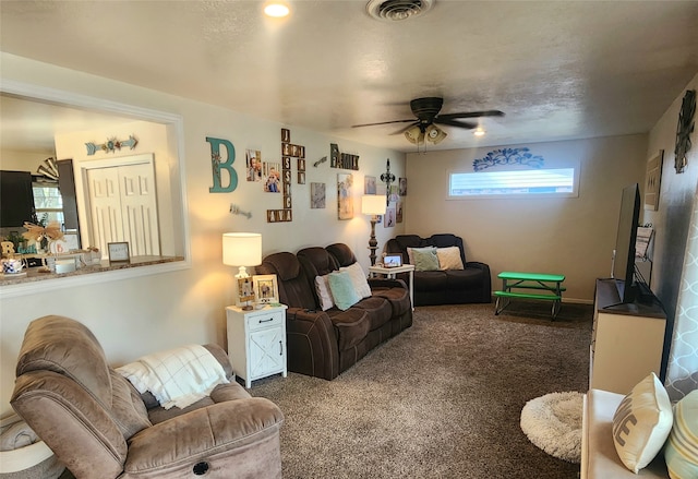 carpeted living room with ceiling fan and plenty of natural light