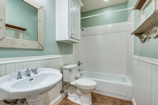 full bathroom featuring sink, washtub / shower combination, and toilet