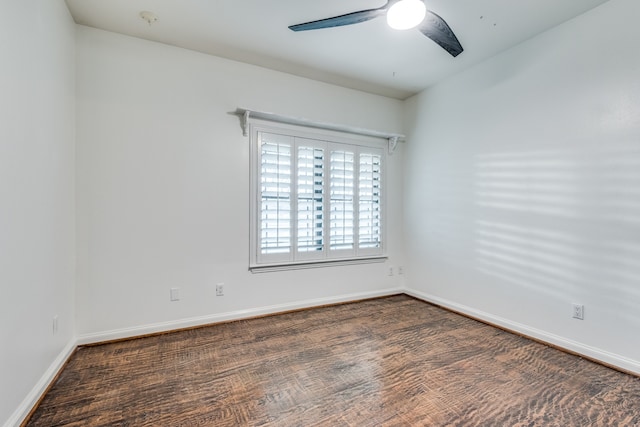 unfurnished room featuring dark wood-type flooring and ceiling fan