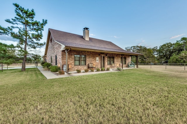 rear view of house with a lawn