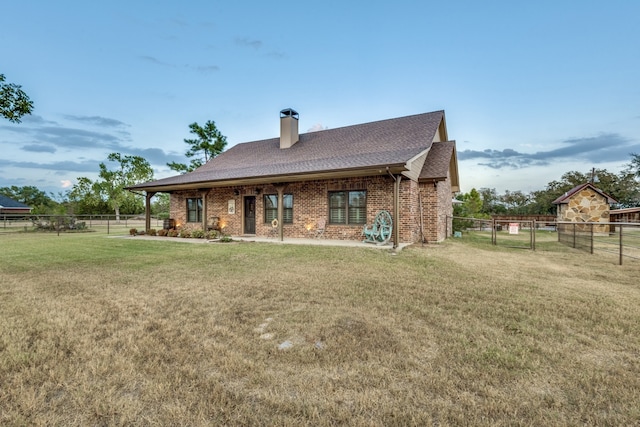 back of house with a yard