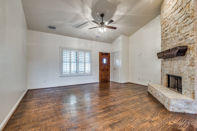 unfurnished living room with a stone fireplace, ceiling fan, and dark hardwood / wood-style flooring