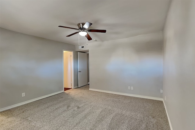 spare room with ceiling fan and light carpet