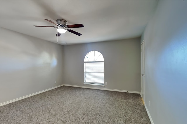 unfurnished room with ceiling fan and carpet