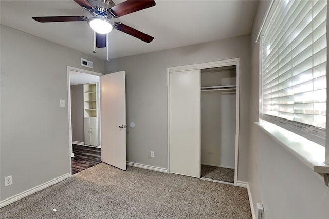 unfurnished bedroom with carpet, a closet, and ceiling fan