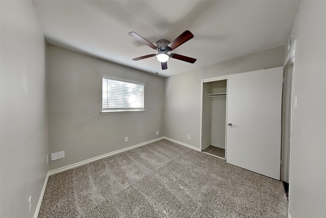 unfurnished bedroom with carpet flooring, ceiling fan, and a closet