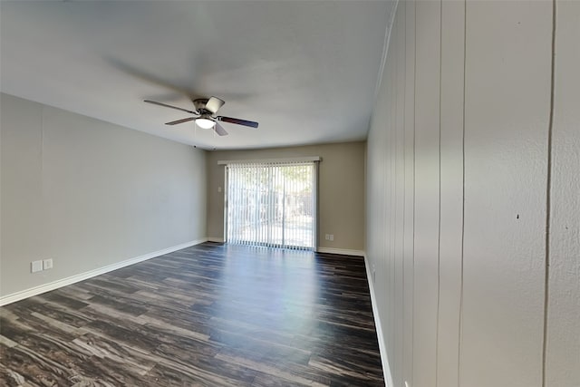 spare room featuring ceiling fan and dark wood-type flooring