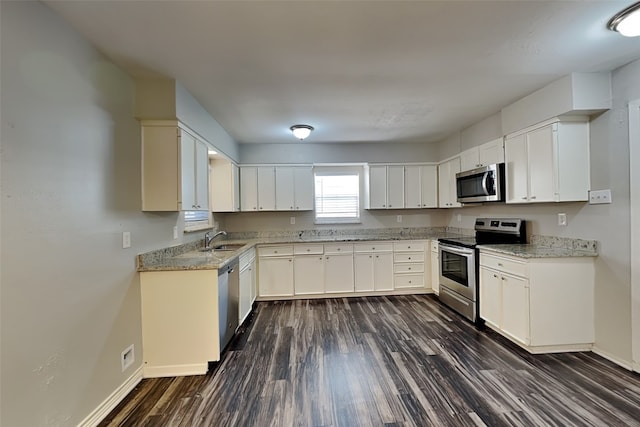 kitchen with sink, white cabinets, stainless steel appliances, and dark hardwood / wood-style floors