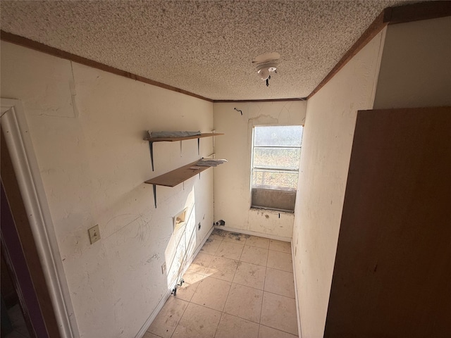 laundry area featuring crown molding and a textured ceiling