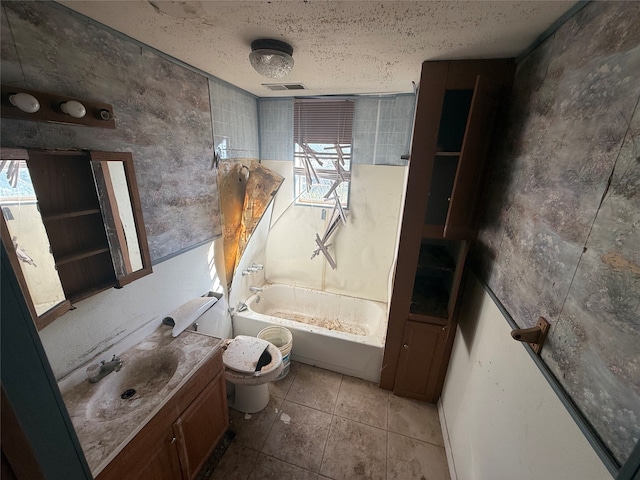 full bathroom featuring a textured ceiling, toilet, tile patterned floors, vanity, and tiled shower / bath combo