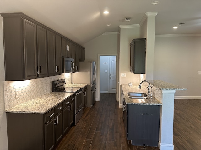 kitchen with dark wood-type flooring, stainless steel appliances, sink, vaulted ceiling, and light stone counters