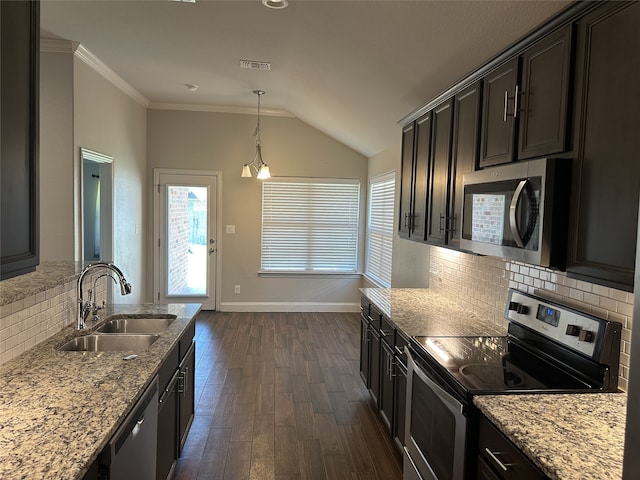 kitchen featuring light stone countertops, sink, backsplash, dark hardwood / wood-style flooring, and stainless steel appliances