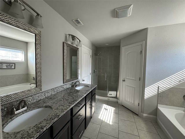 bathroom with vanity, tile patterned floors, and separate shower and tub