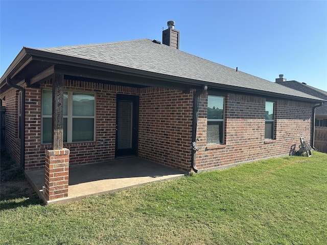 view of front facade with a front lawn and a patio